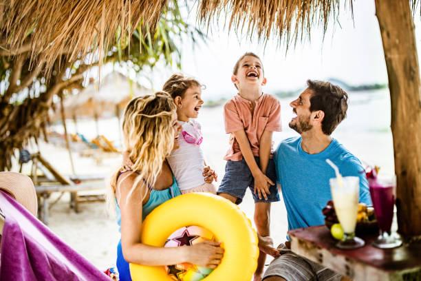 Image of a family on holiday. Parents fined £41 million for term-time holidays. But still save nearly £600 doing so. Find out about school fines and debts