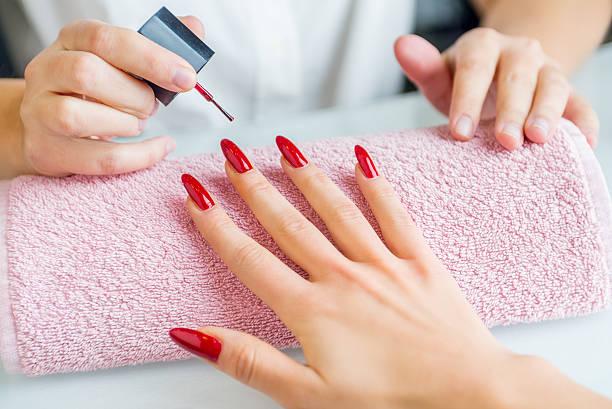 Image of someone having her nails done. Getting your nails done will be more expensive from today. Beauty saving hacks