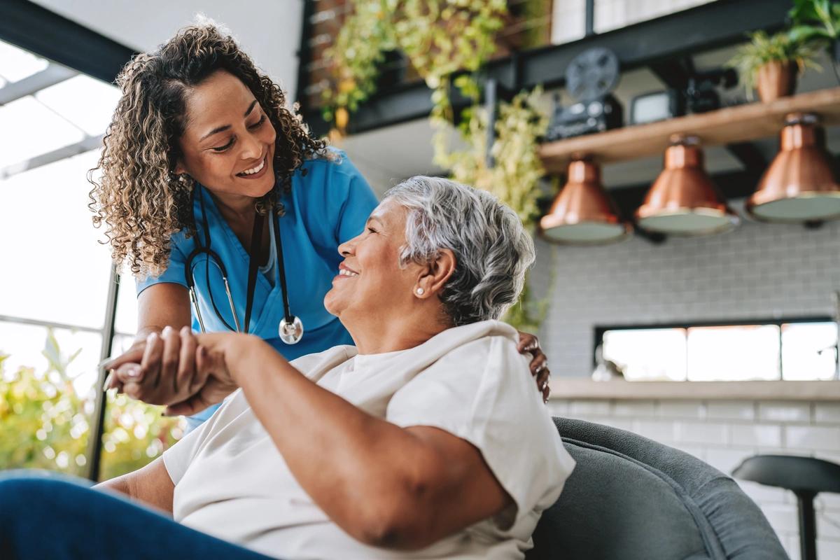 A home healthcare patient talks to her carer