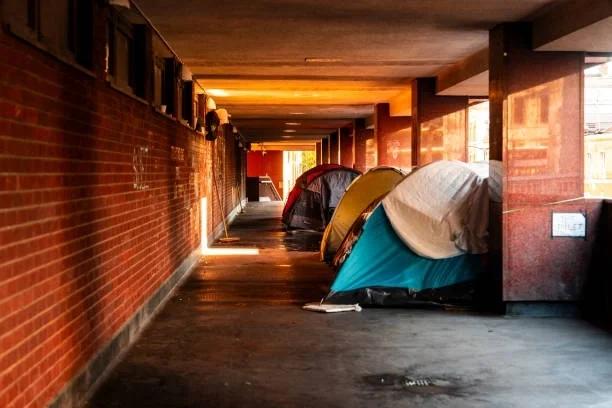 Image of a row of tents in an alley way.  Government doubles funding to help people sleeping rough off the streets. The government has promised everyone sleeping rough a way off the streets by Christmas. Here’s how money problems can put your home at
