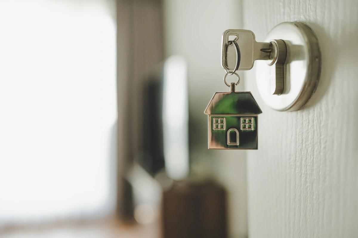 A key in the open front door to a rental property