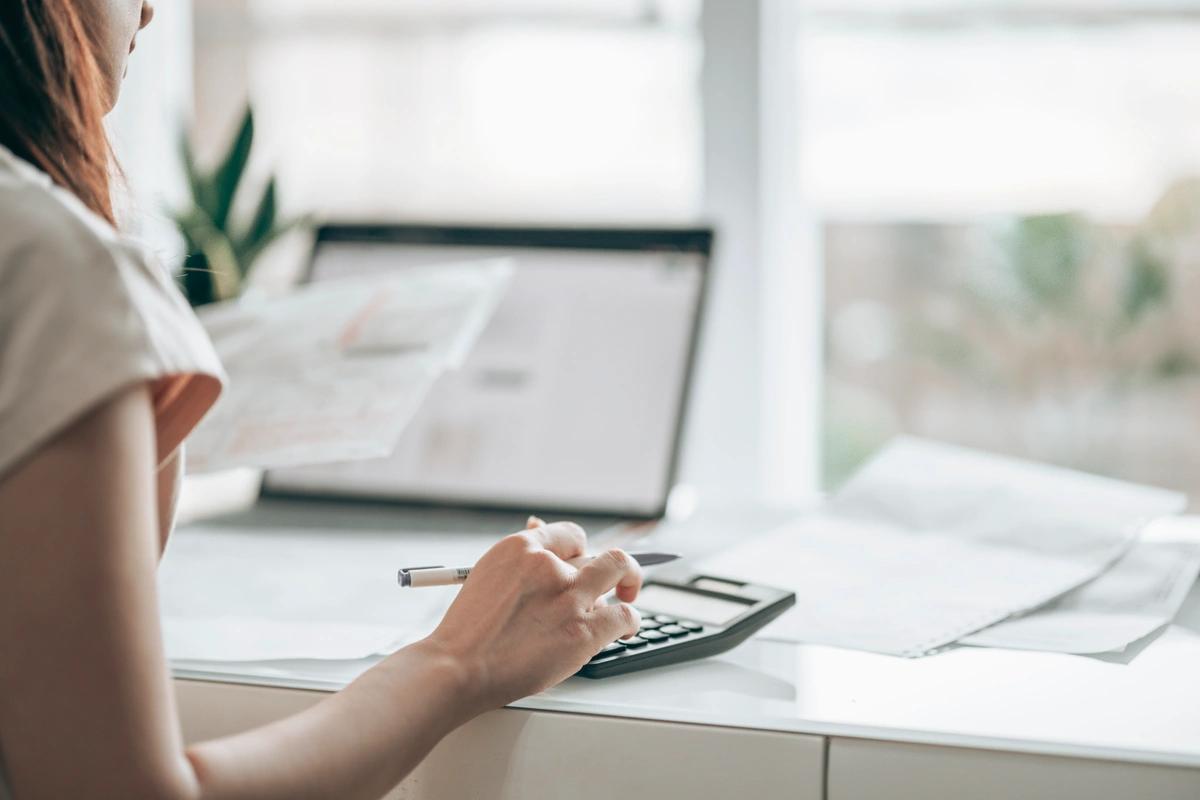 Woman sitting at a desk working out a budget