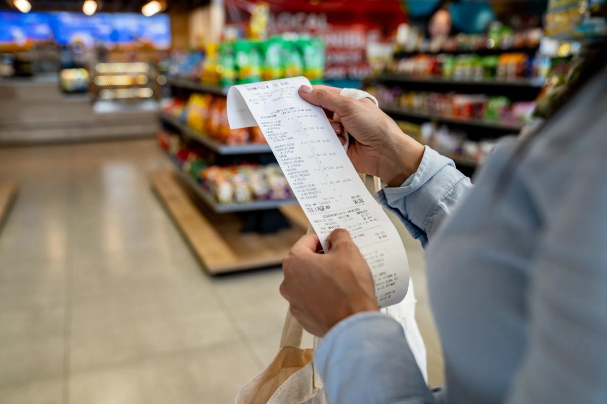 A woman checks her supermarket receipt