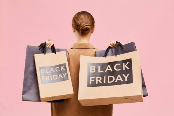 Image of a woman holding lots of shopping bags with Black Friday on