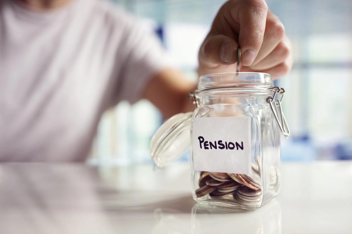 Someone puts a coin in a jar labelled 'Pension'