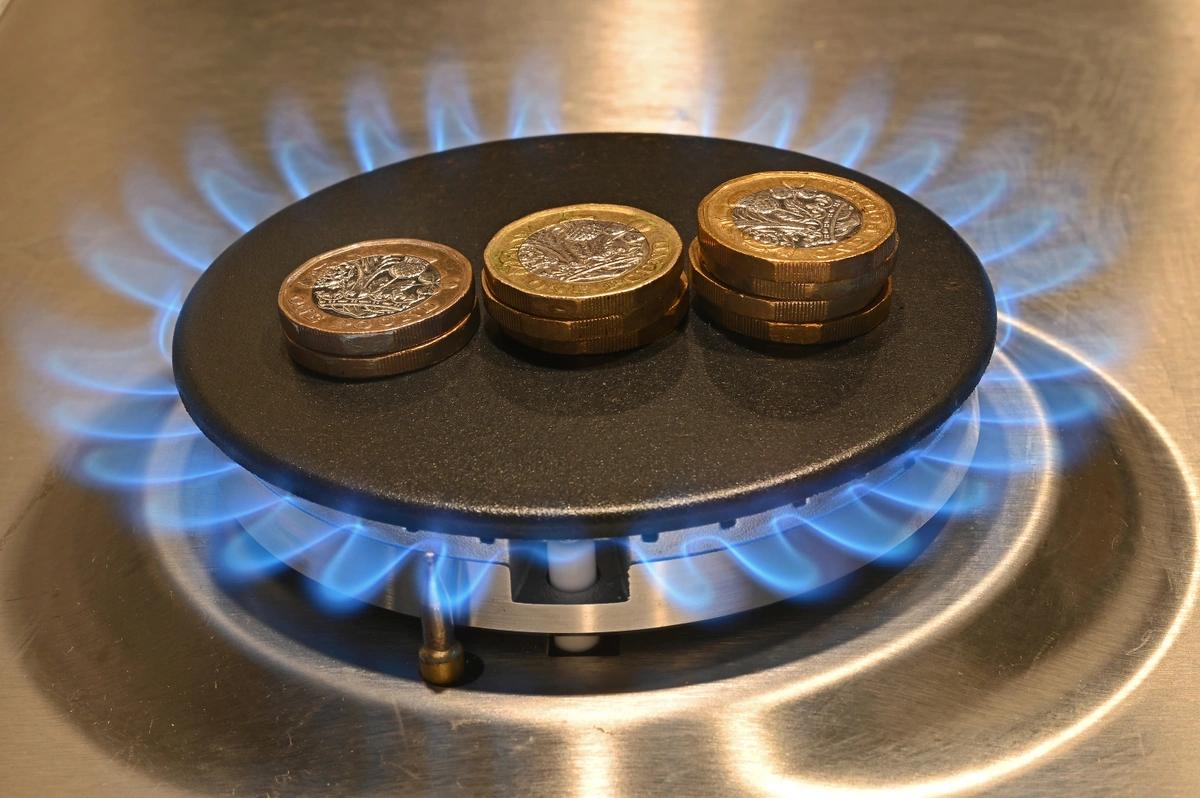 Pound coins in the centre of a lit gas ring