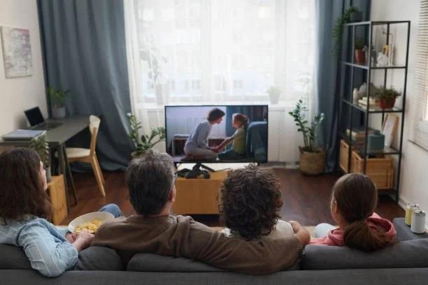 Image of a family watching TV. TV licence fee expected to rise above £180 next April