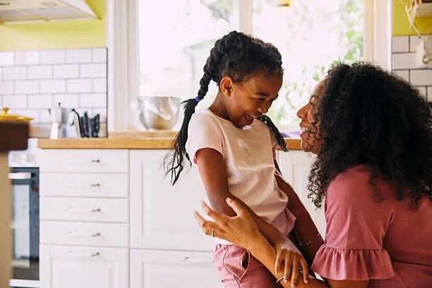Image of a mum laughing with a younger daughter. Single parents could be worse off if they marry, new analysis suggests. What this new analysis could mean for single parents and their money