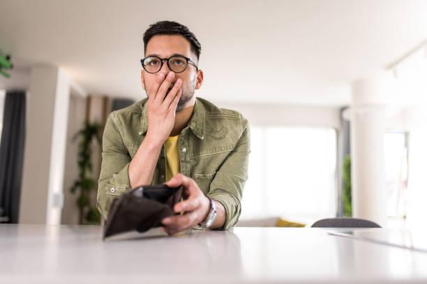 Picture of someone looking in their empty wallet and looking shocked. 8 million could be worse off by 2030 – even if wages go up. How fiscal drag could be making you feel poorer