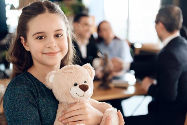 Image of a happy looking girl holding a teddy