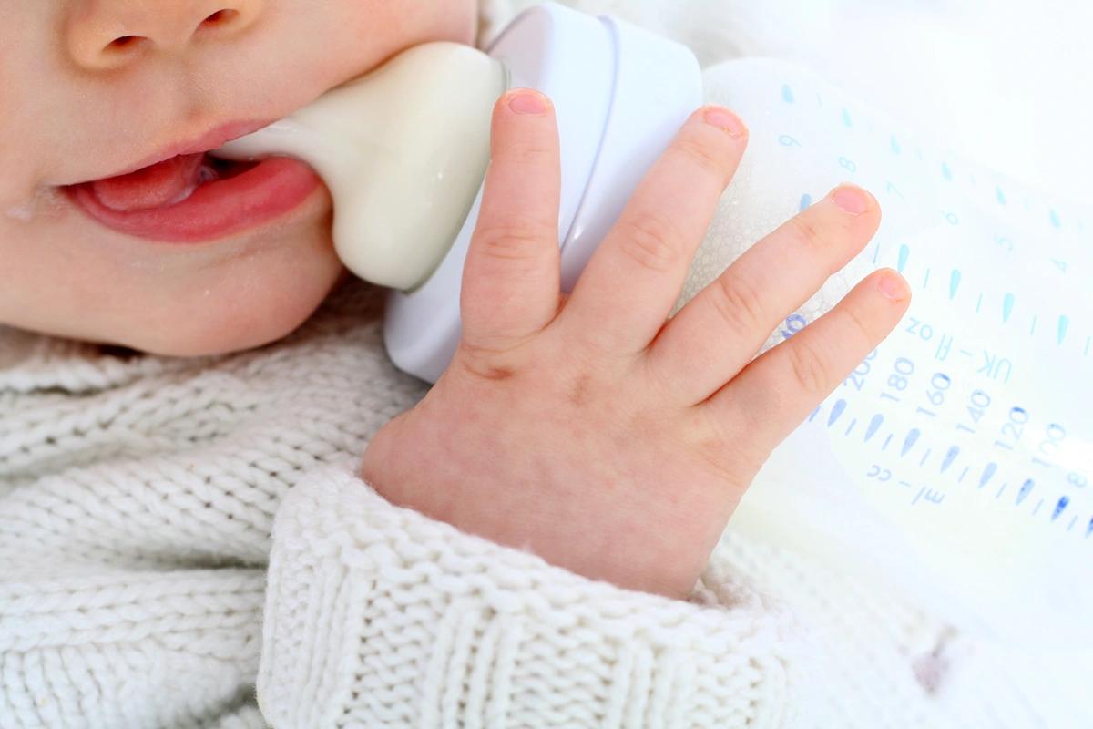 Baby drinking formula from a bottle