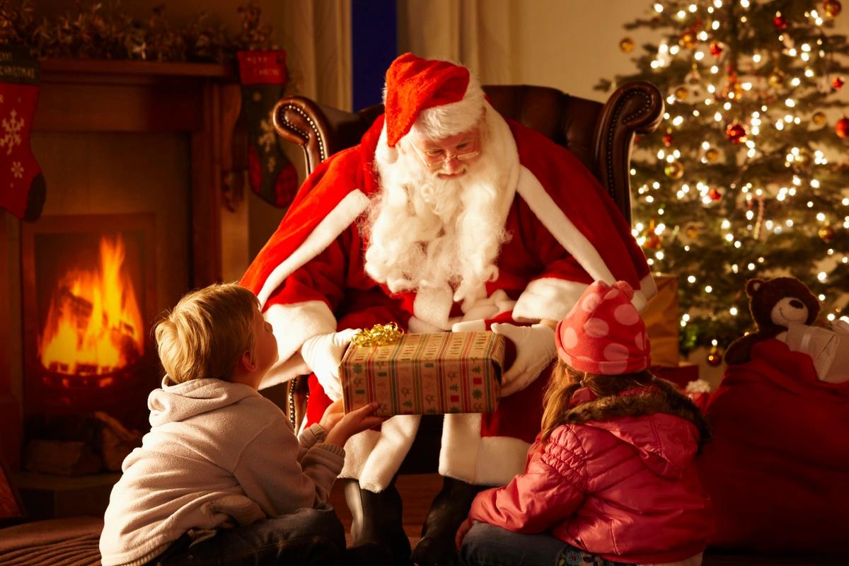 Two children visiting Santa in his grotto