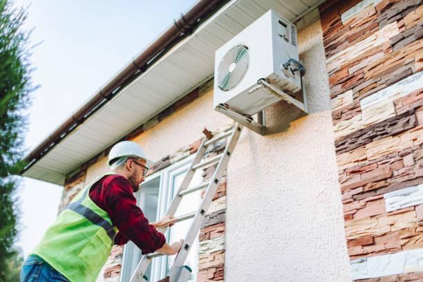 Image of a man installing a heat pump