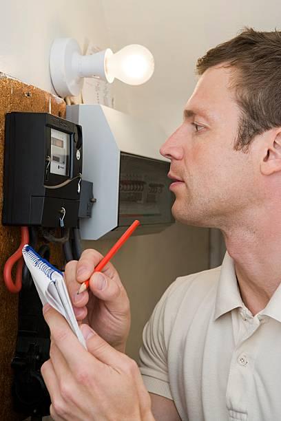 Image of a man taking a meter reading and writing down the figures. Just four days left to avoid paying more than you should as energy bills jump on 1 July. Millions face higher gas and electricity bills next week - here's the simple check that could