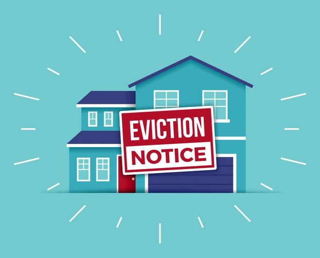 blue house with a sign that reads 'eviction notice' on the front
