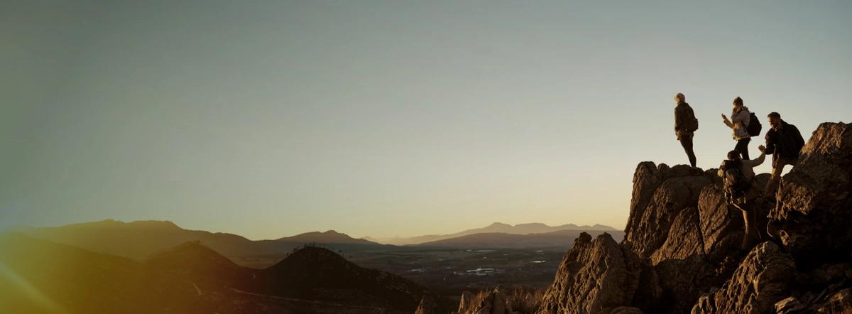 Group of climbers reaching the top of a mountain