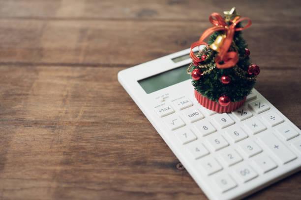 Image of a calculator with a little Christmas tree on top