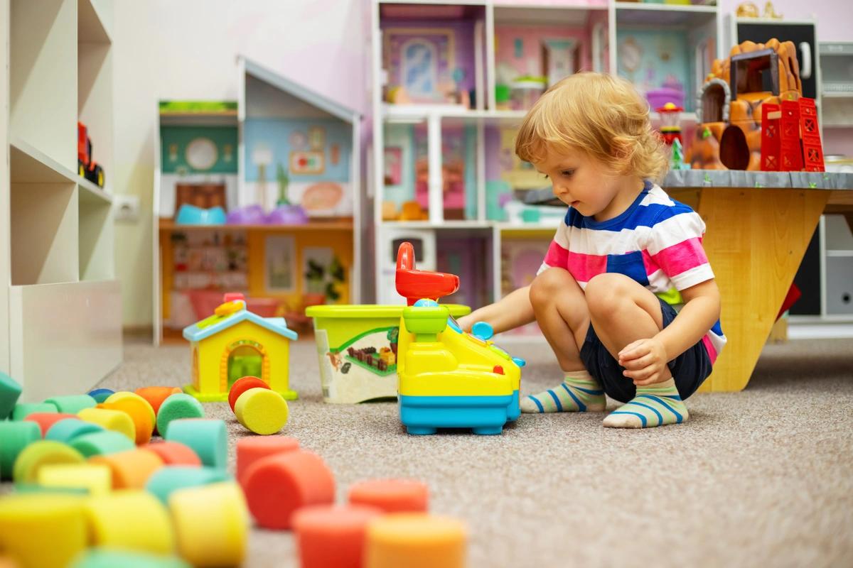A child plays with colourful toys at nursery