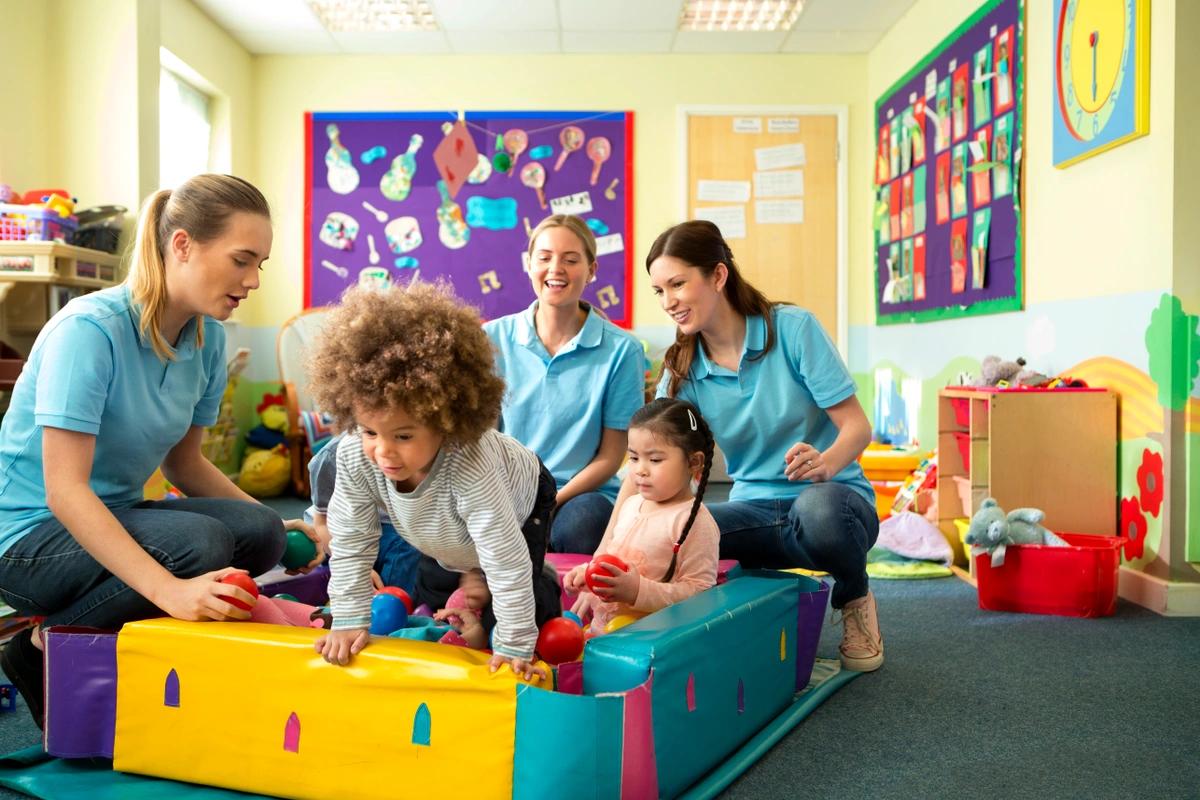 Children and staff playing together at a nursery