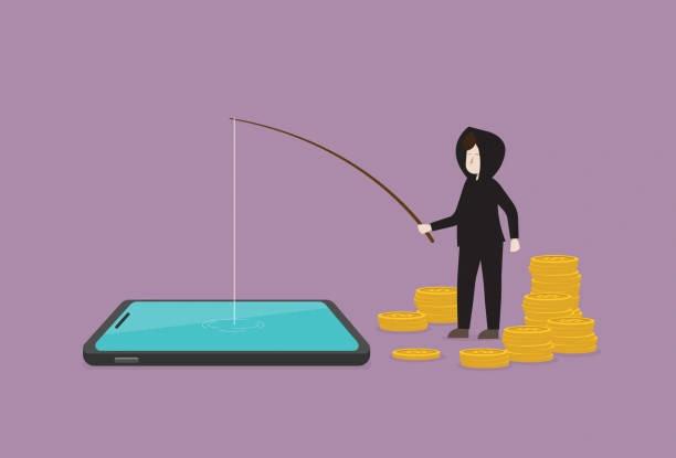 Image of a man dressed in black with his hood up and money around him fishing into a smart phone. Advice to the victims of phishing and LabHost