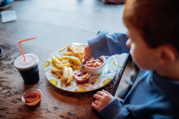 Image of a toddler eating a meal. All the places kids eat free Easter 2024