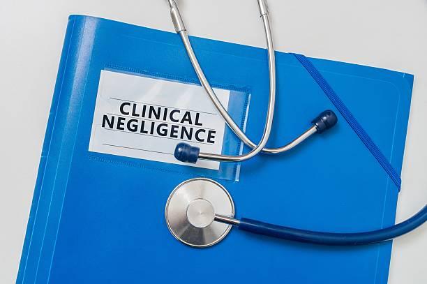 Image of medical notes with a tag that says clinical negligence and a stethoscope on top
