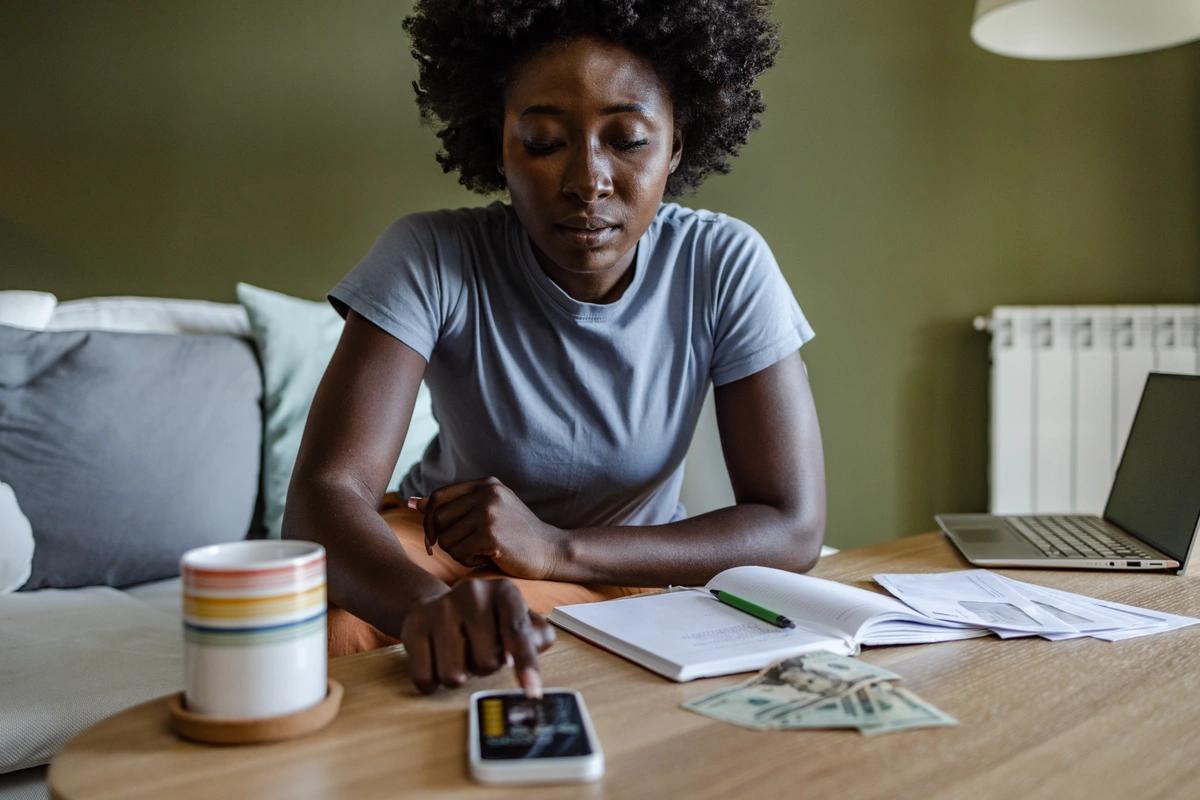 A worried-looking woman goes through her finances
