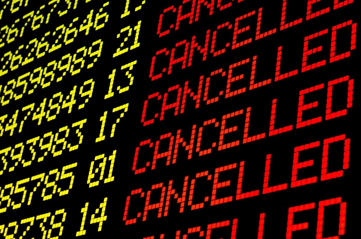 A board at an airport listing cancelled flights