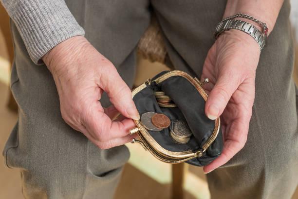 Image of someone looking inside a coin purse where there is some change. Final cost of living payment - are you eligible and how to claim