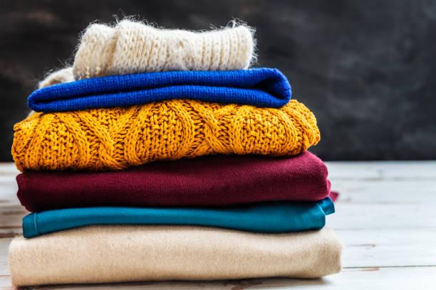 Image of a pile of wool jumpers. Protect your clothes and save money this moth season