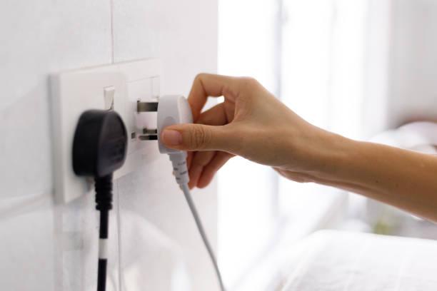 Image of someone plugging a plug into a switch. Warm home discount scheme - get £150 towards your electricity