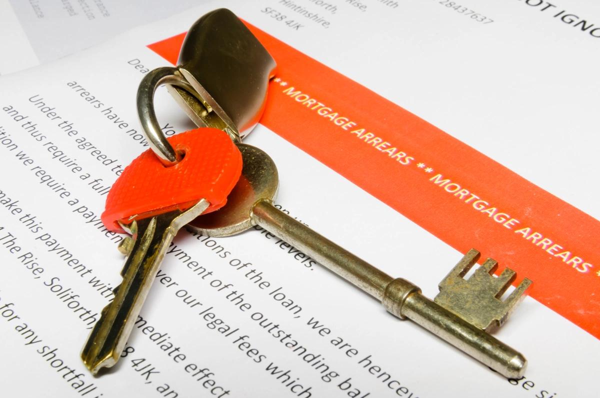 House keys on top of a mortgage arrears letter